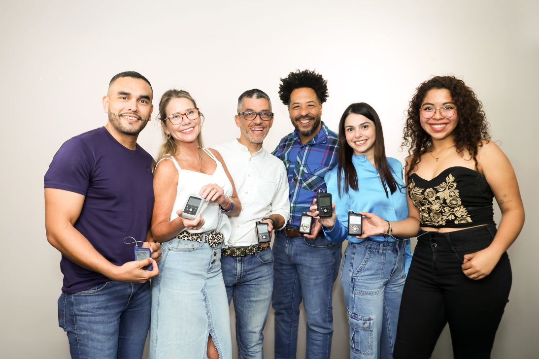 Group of people holding insulin pumps