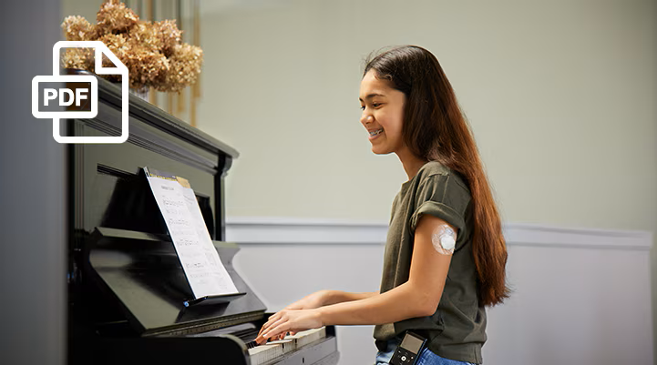 A girl playing the piano, wearing a sensor