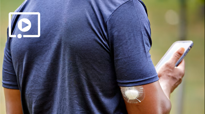 A person with a CGM on the back of their arm