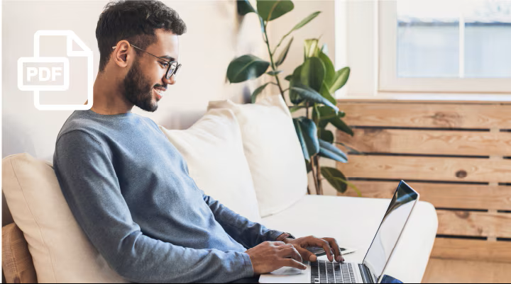 A man sitting on the couch with a laptop