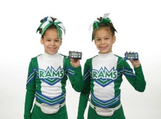 Emily and Ashley holding Paradigm pumps in cheerleading outfits