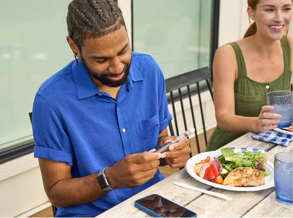 Man holding InPen at mealtime