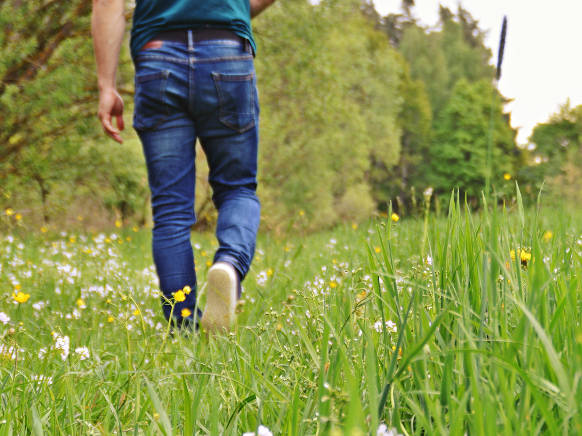 Man walking through field at springtime