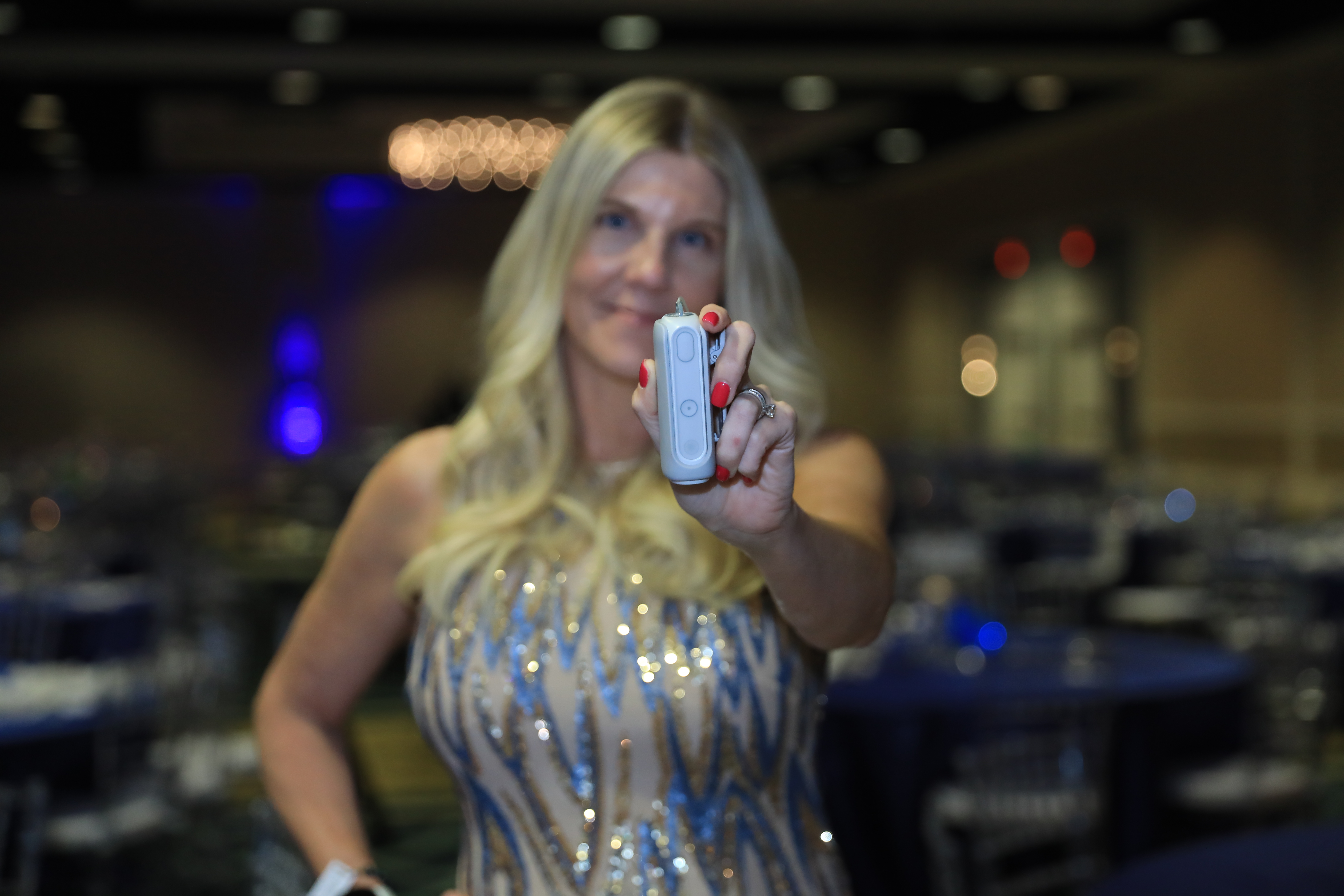 MiniMed employee Jaime Cline holding out her MiniMed Flex pump