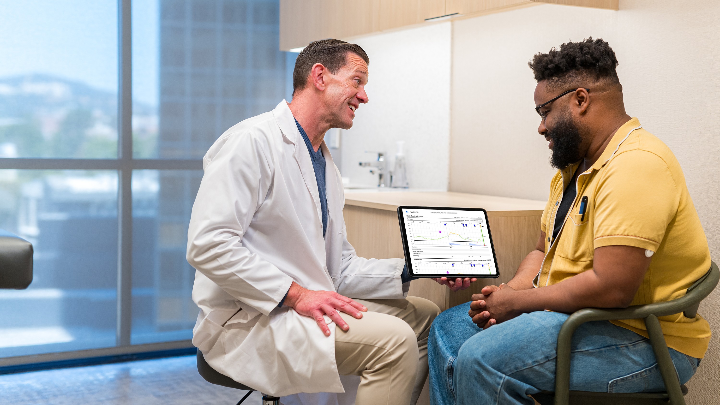 MiniMed Champion Jon at doctors office looking at CareLink reports