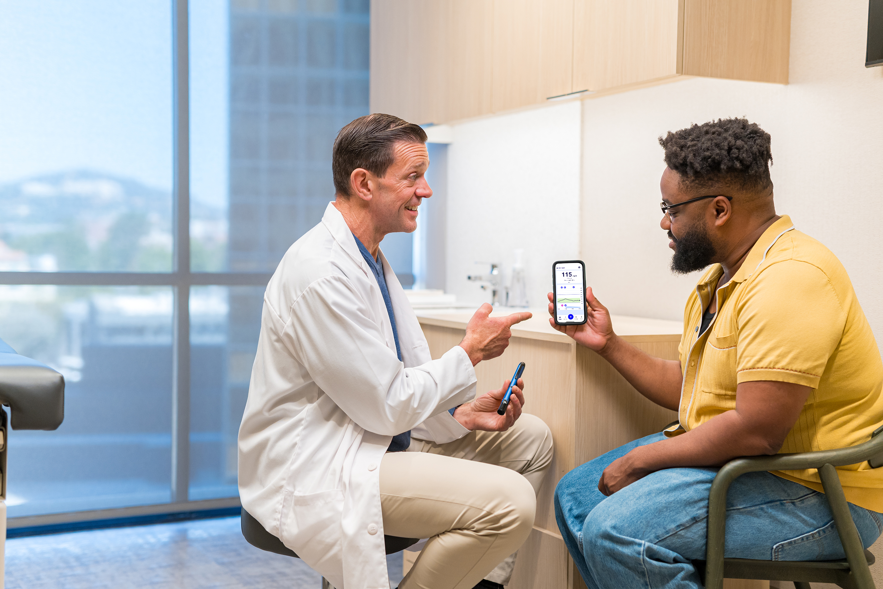Man with HCP looking at MiniMed Go app on patient phone