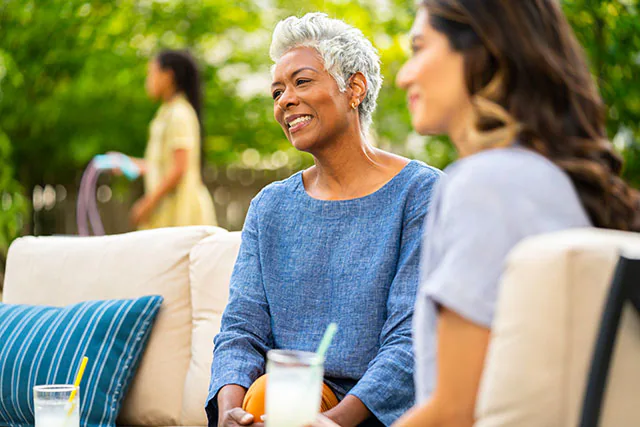 Older woman outside with lemonade