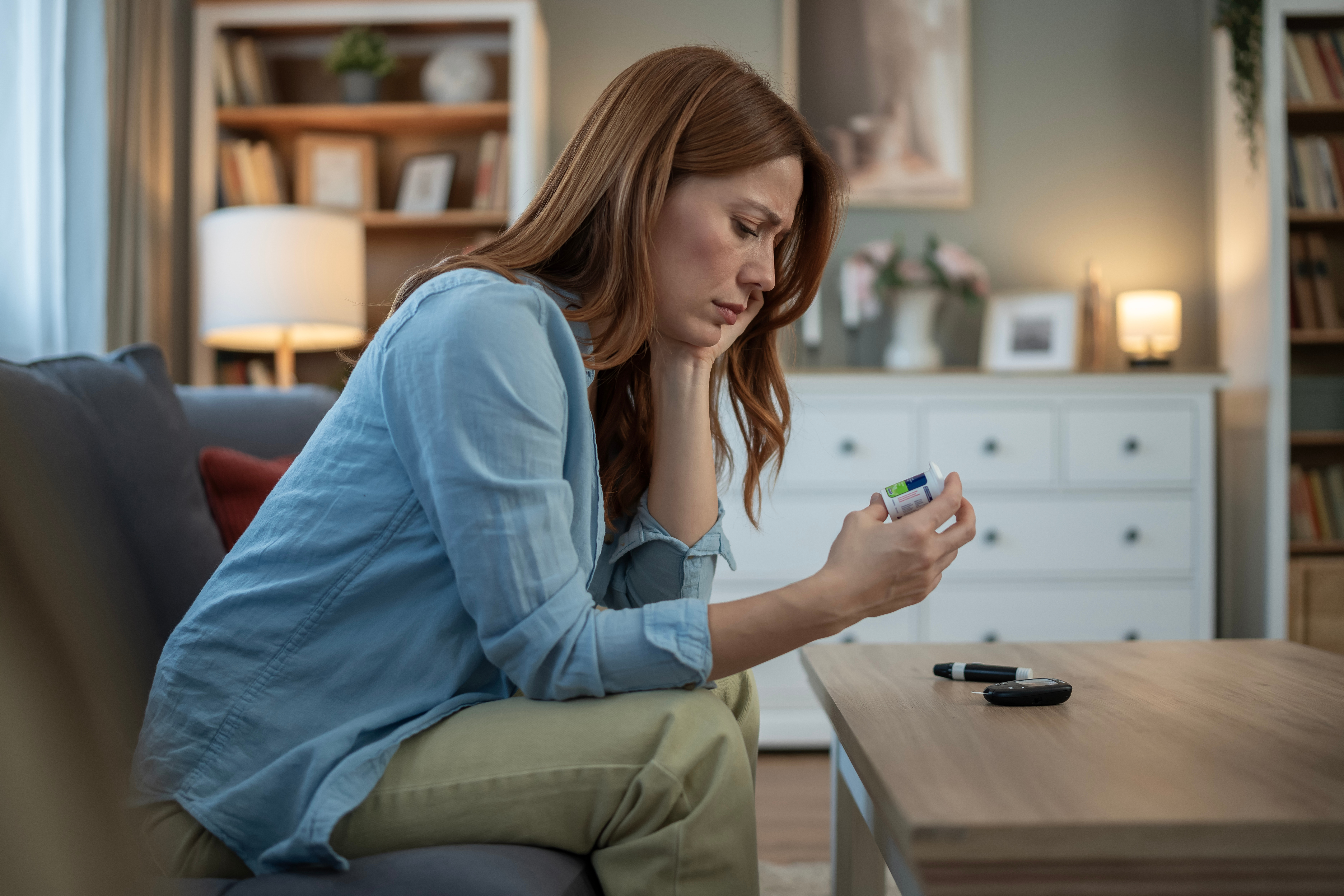 Tired woman checking blood sugar at home